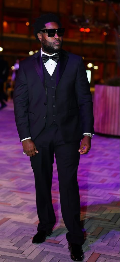 Eugene in a black tuxedo and sunglasses