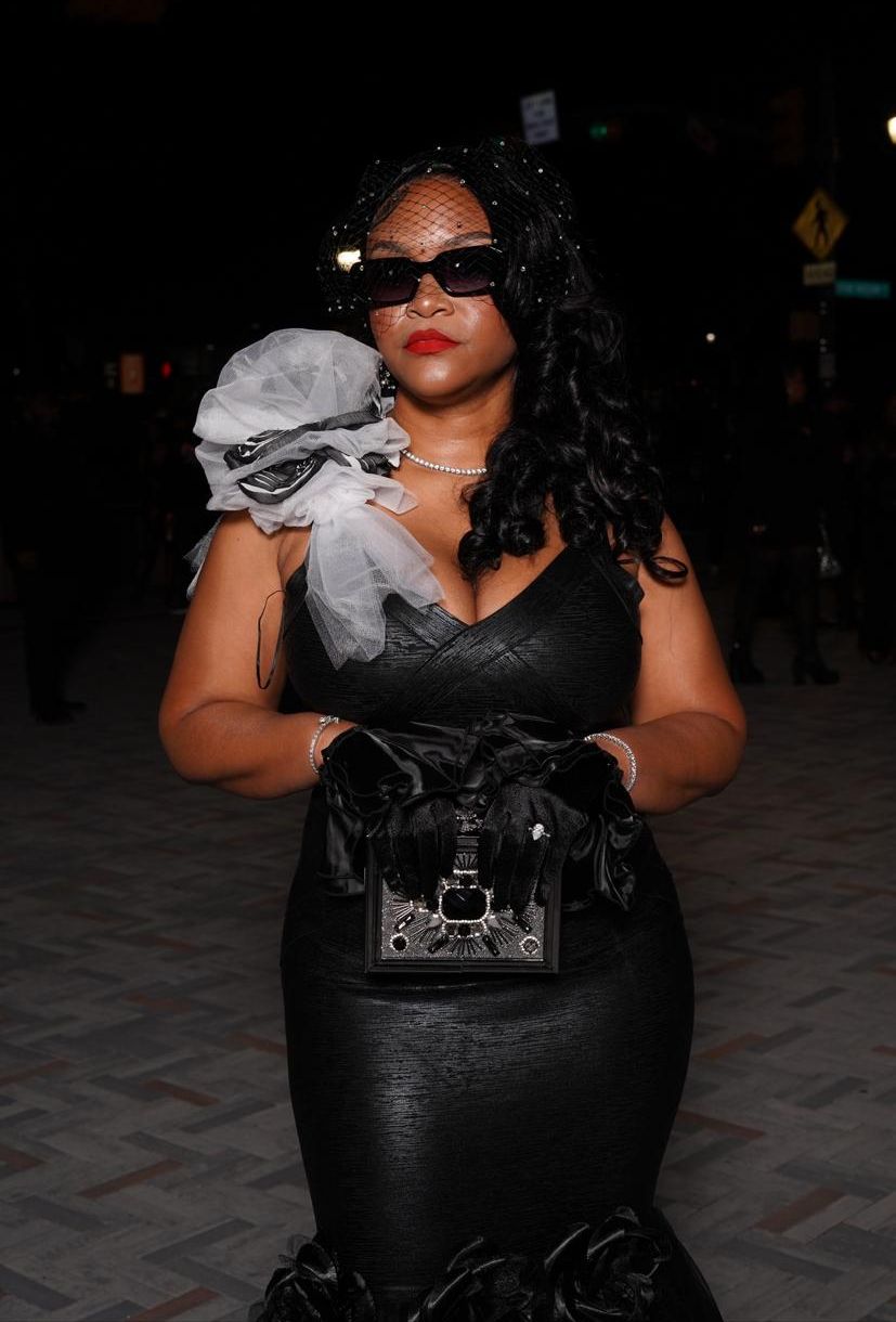 Jessica in a black gown, veil and satin gloves