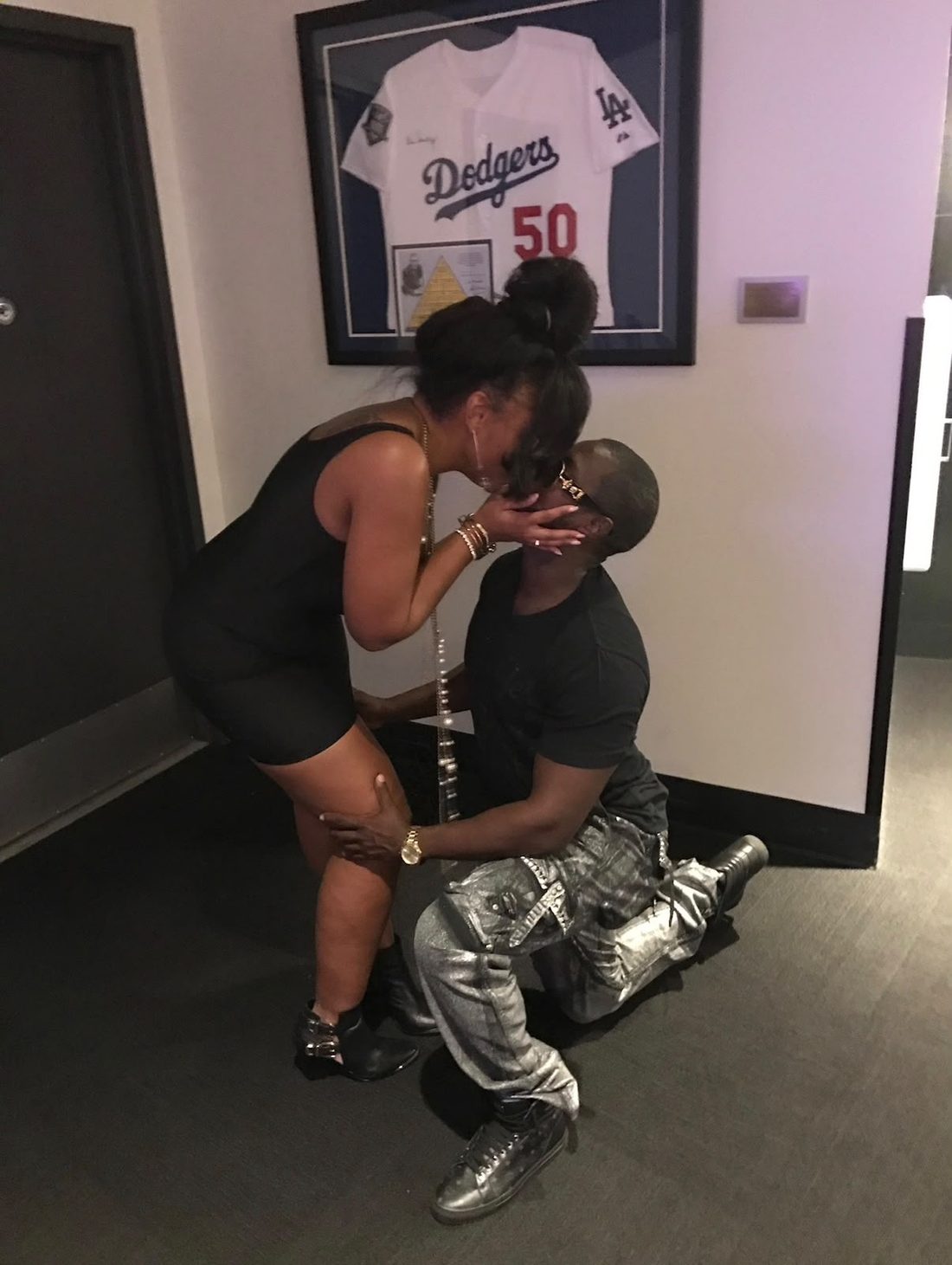 Eugene kneeling as Jessica kisses him