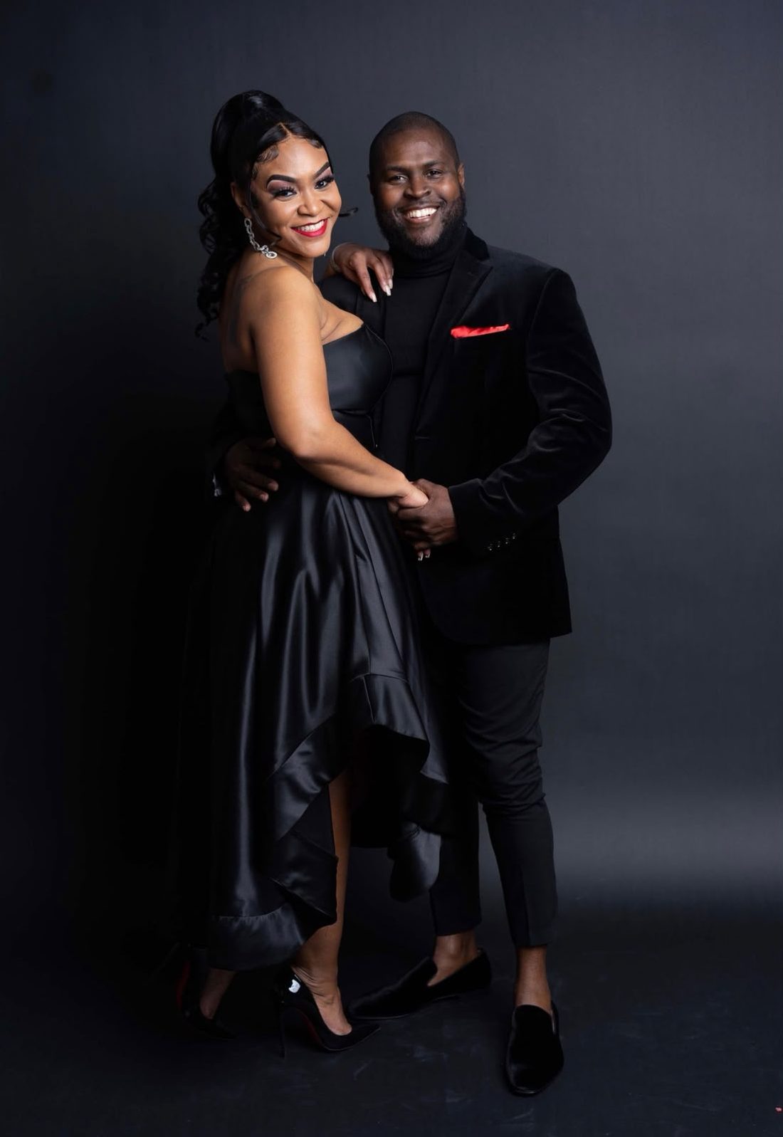 Eugene and Jessica in a studio portrait, both dressed in black